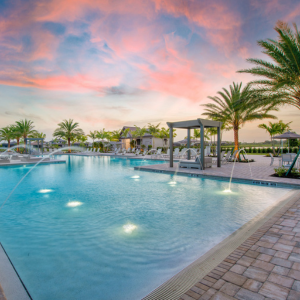 Luxury resort-style swimming pool in Verdana Village in Estero, Florida at Sunset.